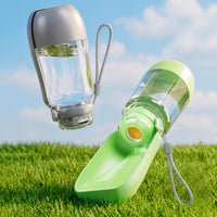 Grey and green ChillBottles on grass, one open with water in the bowl